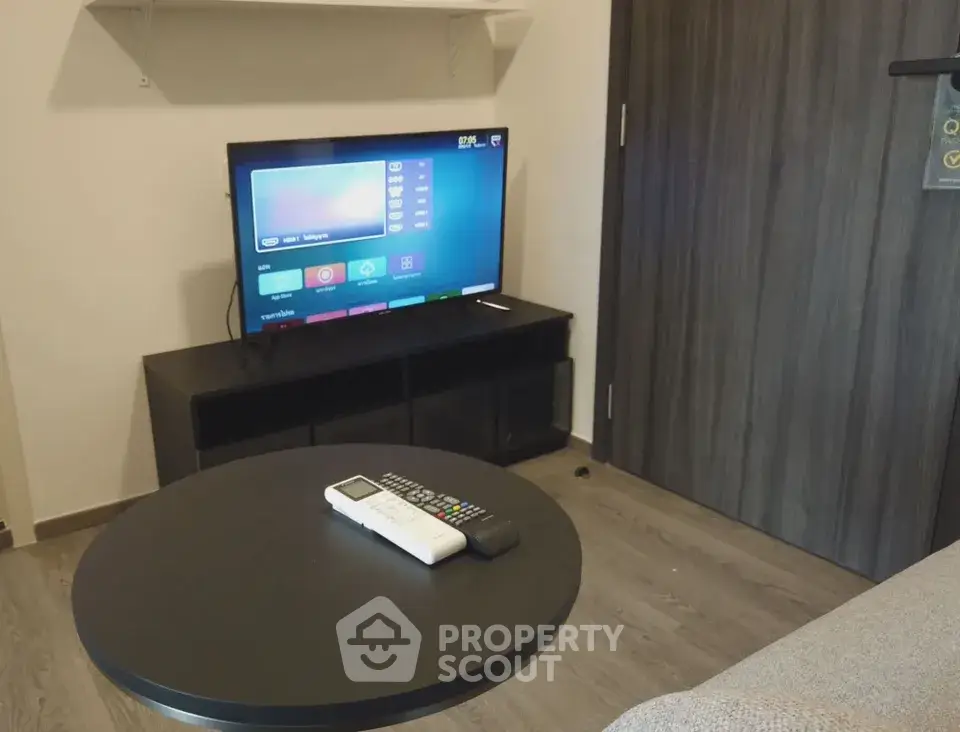 Cozy living room with modern TV setup and sleek furniture