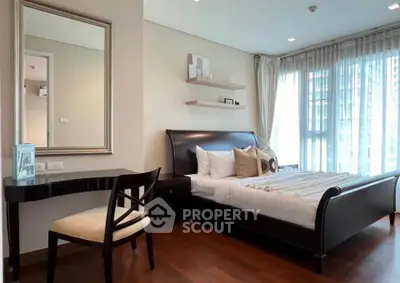 Elegant bedroom with large window, stylish decor, and wooden flooring in modern apartment.