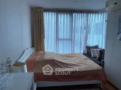 Cozy bedroom with large window and elegant curtains in modern apartment