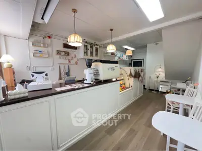 Charming cafe-style kitchen with modern appliances and cozy seating area.