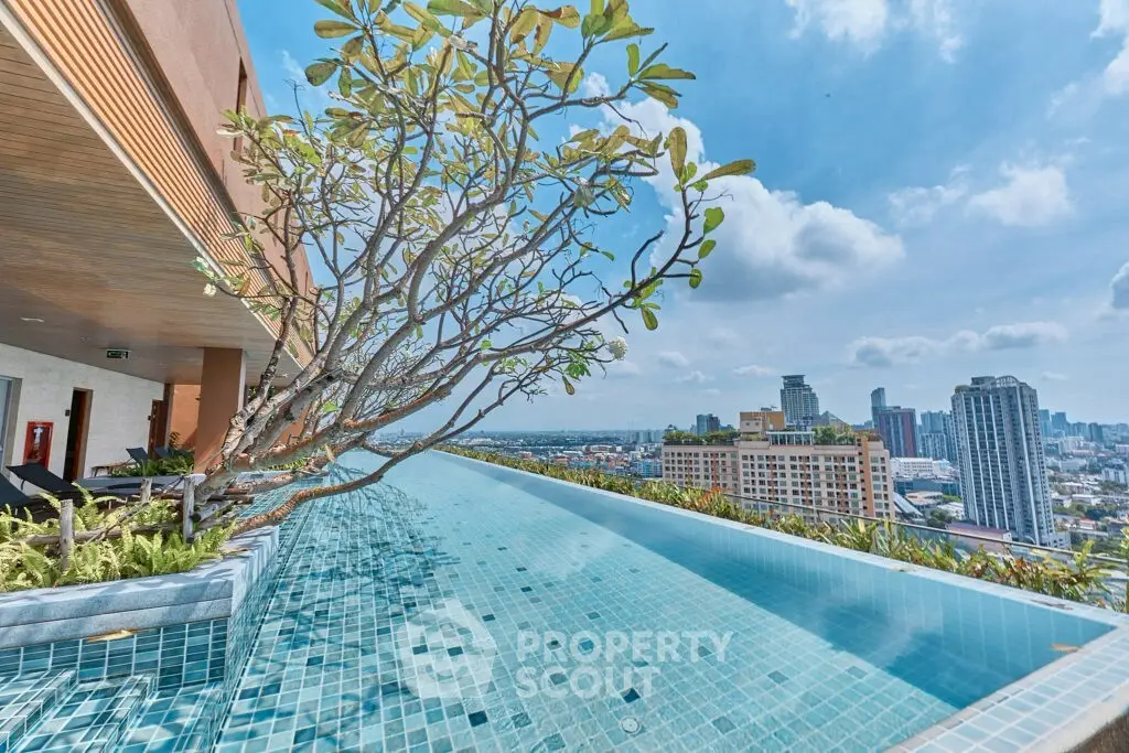 Stunning rooftop infinity pool with panoramic city views and lush greenery.