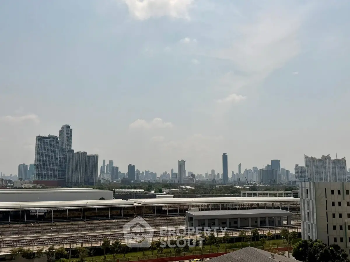 Stunning cityscape view with modern skyline and railway tracks, perfect for urban living enthusiasts.