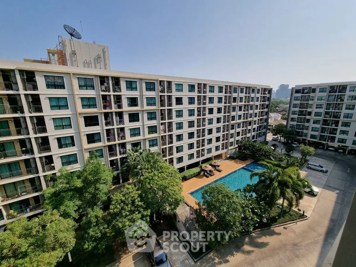 Modern apartment complex with pool and lush greenery, offering urban living with resort-style amenities.