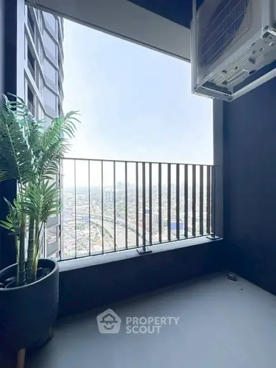 Modern balcony with city view and potted plant, perfect for urban living.
