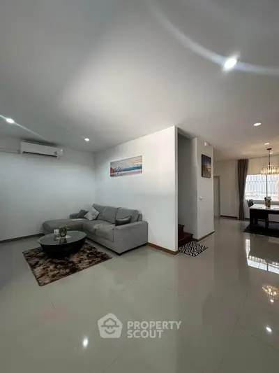 Spacious modern living room with sleek design and cozy seating area.