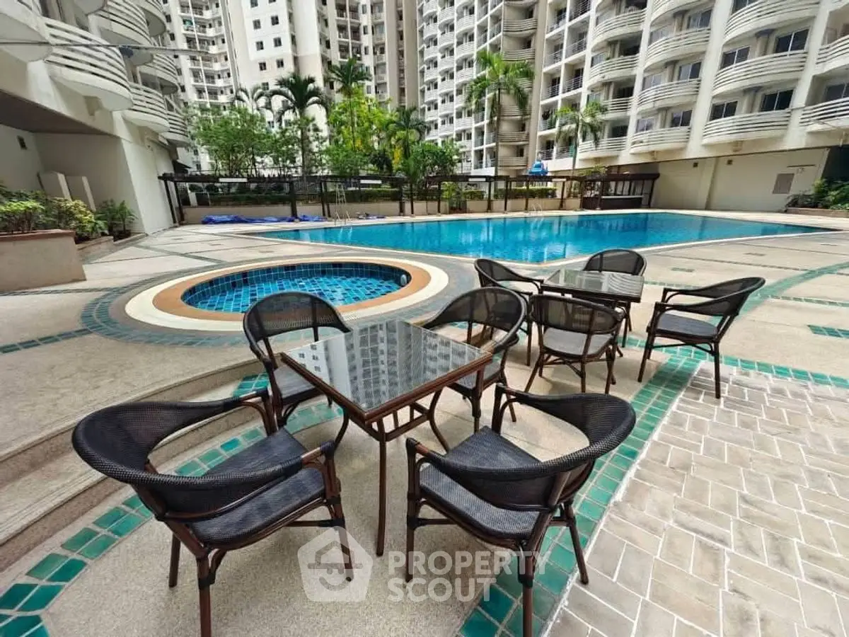 Luxurious residential pool area with stylish outdoor seating and modern architecture.