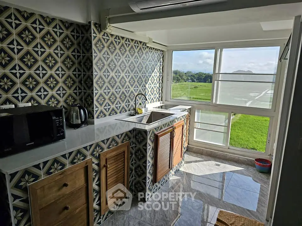 Charming kitchen with scenic view and stylish tile backsplash
