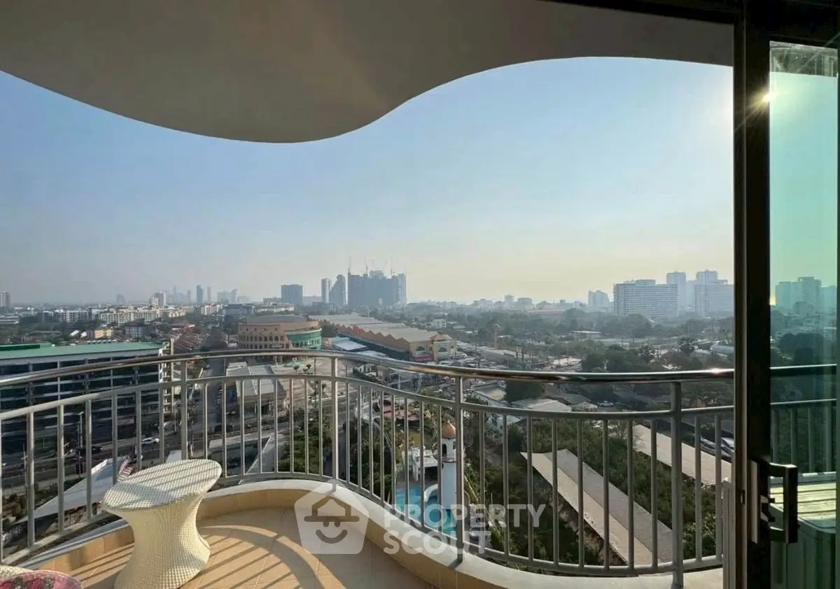 Stunning cityscape view from a spacious balcony with modern railing design.