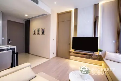 Modern living room with sleek design and large TV, perfect for relaxation and entertainment.