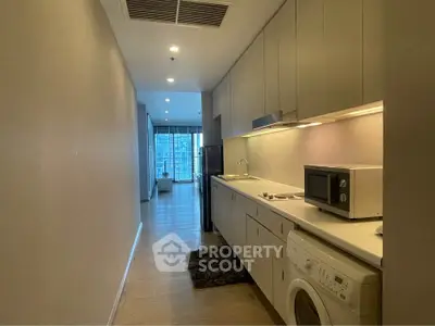 Modern kitchen with sleek cabinetry and appliances in a stylish apartment