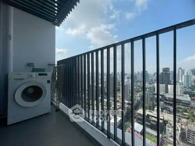 Stunning high-rise balcony with cityscape view and washing machine, perfect for urban living.