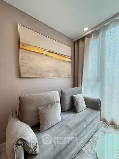 Modern living room with elegant sofa and large abstract painting
