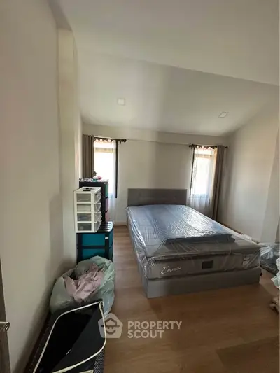 Spacious bedroom with natural light and modern furnishings