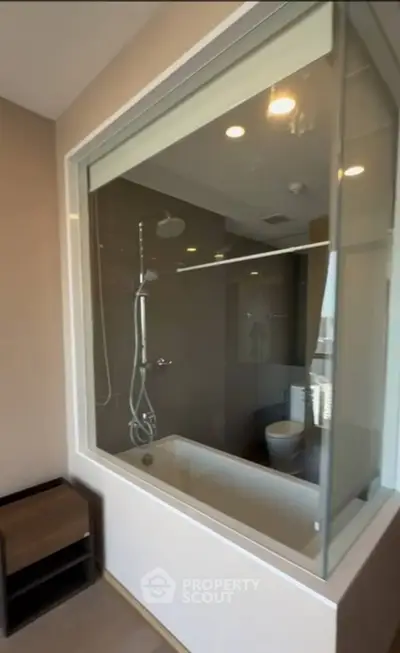 Modern bathroom with glass partition and sleek fixtures