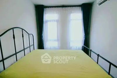 Cozy bedroom with large windows and modern metal bed frame, perfect for natural light lovers.