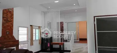 Spacious living room with modern decor and brick accent wall