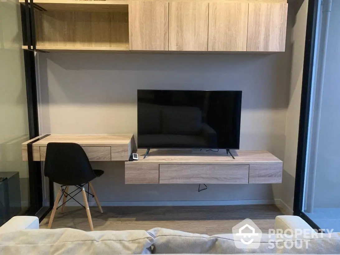 Modern minimalist living room with sleek wooden media console, wall-mounted shelves, and cozy seating, perfect for urban living.