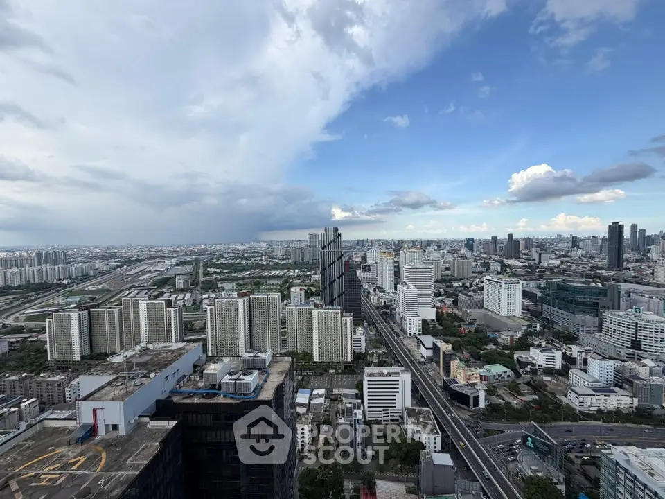 Stunning cityscape view showcasing modern high-rise buildings and expansive skyline under a vibrant blue sky.