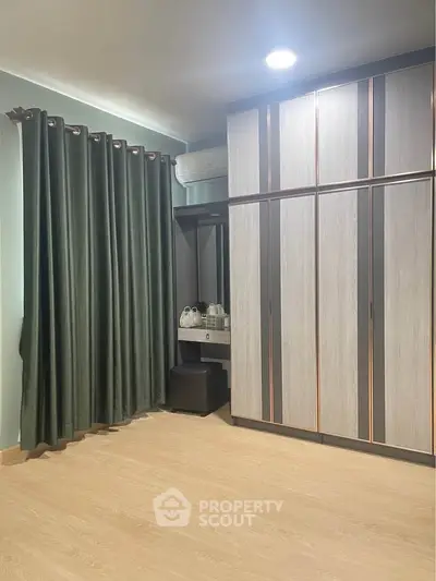 Modern bedroom with sleek wardrobe and elegant curtains