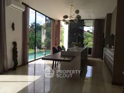 Luxurious kitchen with island and pool view in modern home