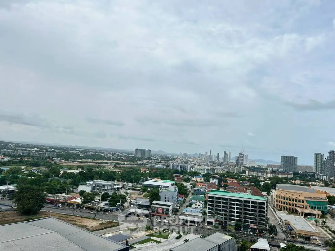 Stunning cityscape view showcasing urban skyline and residential buildings under a vast sky.