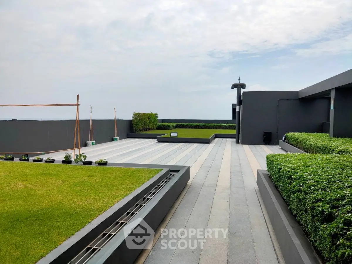 Stunning rooftop terrace with lush greenery and ocean views, perfect for relaxation and entertainment.