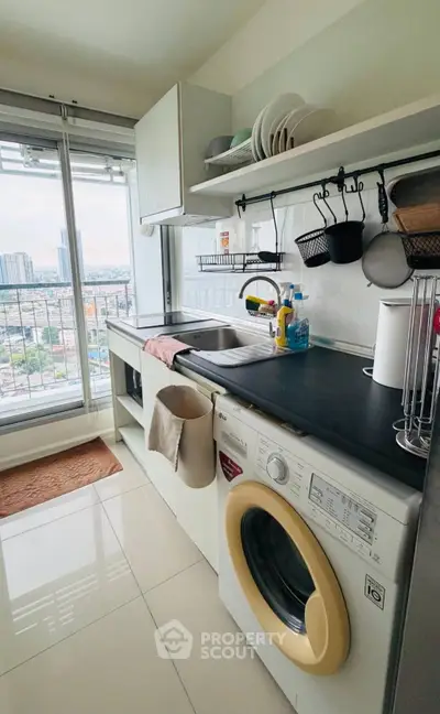 Modern kitchen with city view, featuring washing machine and sleek open shelving.