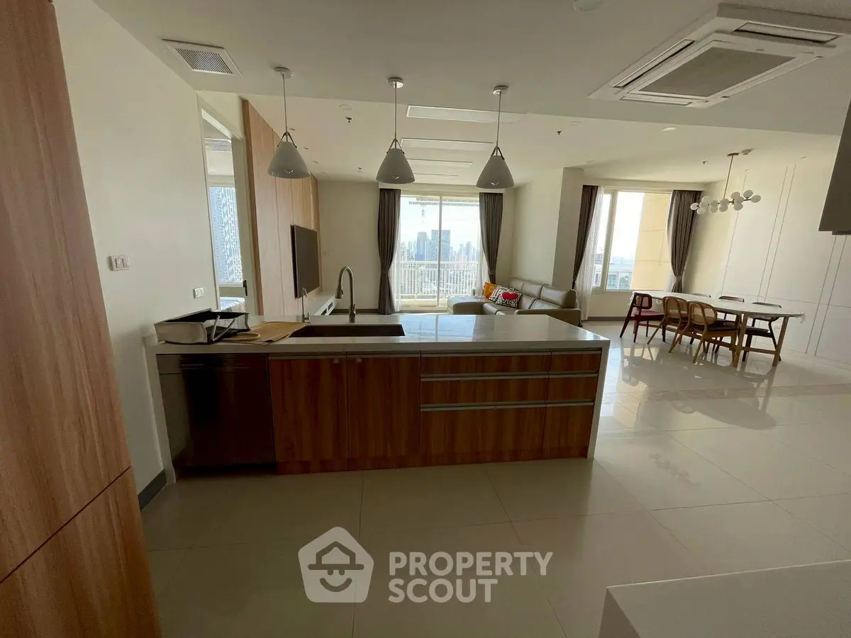 Spacious modern kitchen with open layout and city view, ideal for entertaining.