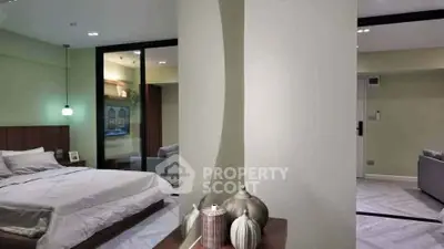 Modern bedroom with stylish decor and adjoining living area