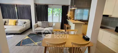 Modern open-plan living and dining area with stylish furniture and natural light.