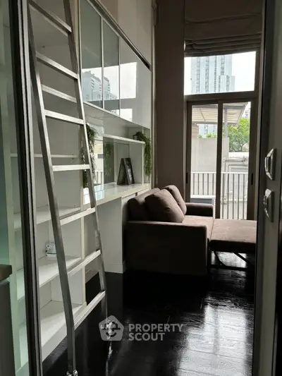 Modern living room with sleek ladder and balcony view in urban apartment