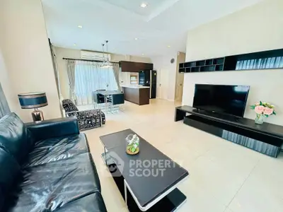 Spacious modern living room with sleek furniture and open kitchen layout, perfect for contemporary living.
