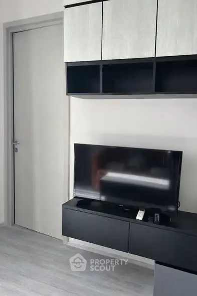 Modern living room with sleek TV unit and storage cabinets