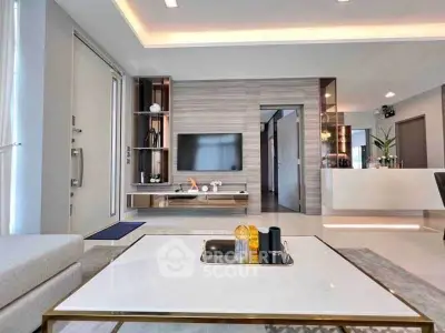 Modern living room with sleek design and open layout, featuring a stylish TV unit and contemporary decor.