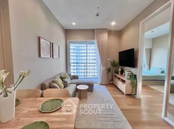 Modern living room with cozy decor and natural light in a stylish apartment.