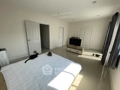 Spacious bedroom with modern decor and ample natural light