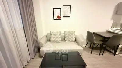 Modern living room with cozy sofa and dining area in stylish apartment.