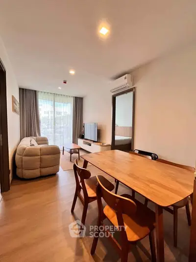 Modern living room with stylish furniture and natural light, perfect for relaxation and entertainment.