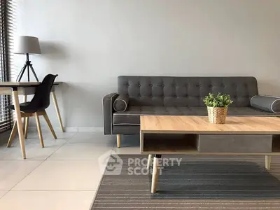 Modern living room with stylish gray sofa and wooden coffee table