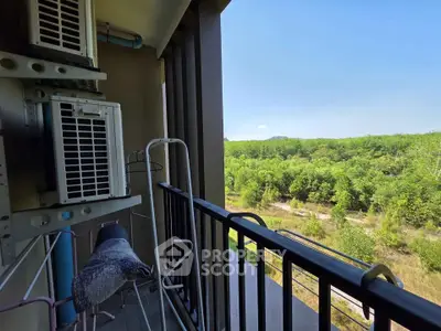 Charming balcony with lush green view, perfect for relaxation and enjoying nature's tranquility.