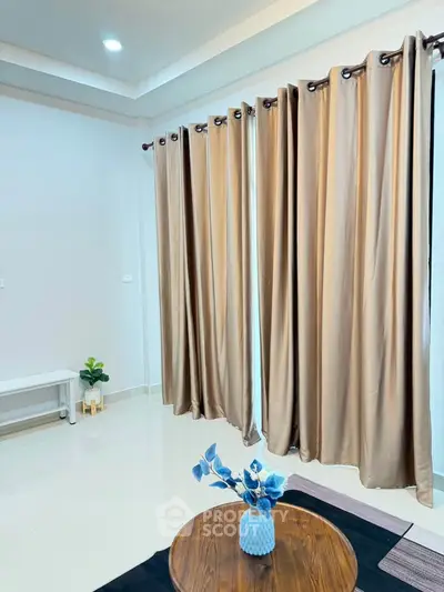 Elegant living room with floor-to-ceiling curtains and stylish decor