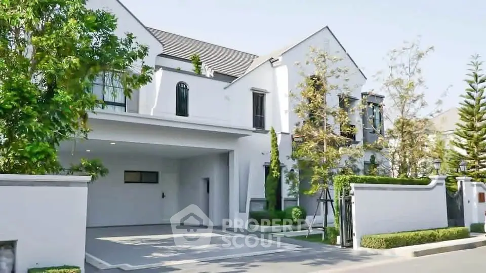 Elegant modern house exterior with spacious driveway and lush greenery