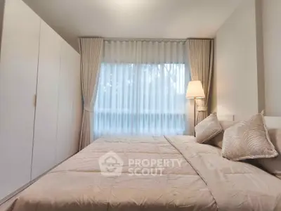 Cozy bedroom with elegant curtains and soft lighting, featuring a comfortable bed and spacious wardrobe.
