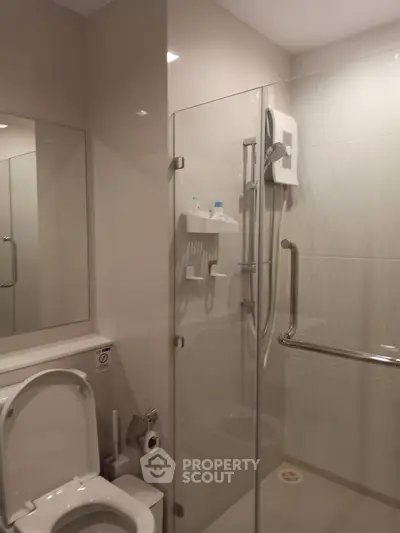 Modern bathroom with glass shower enclosure and sleek fixtures