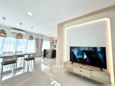 Modern open-plan living room with sleek furniture and ample natural light.