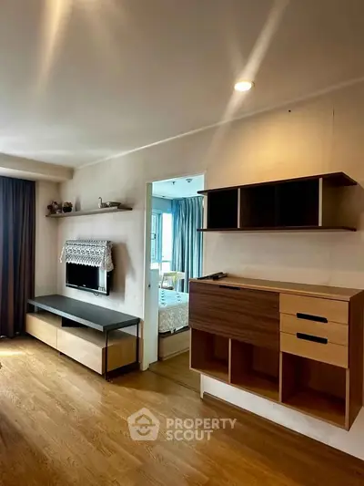 Modern living room with wooden flooring and stylish shelving units