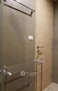 Modern bathroom with sleek design and towel rack, ideal for contemporary living.