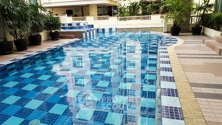Luxurious residential pool with modern design and lush greenery