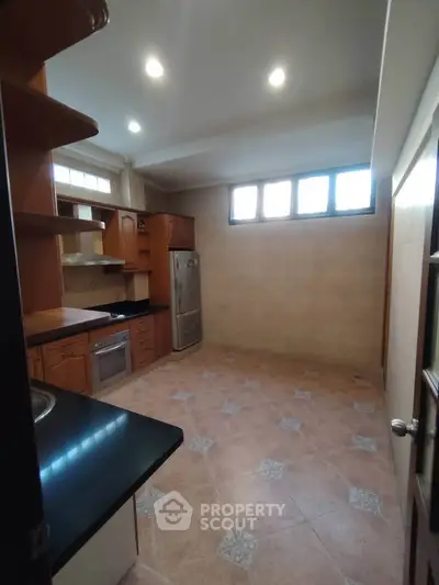 Spacious kitchen with modern appliances and ample storage space