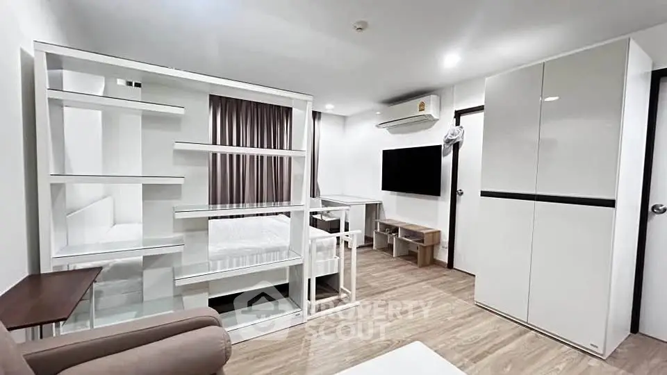 Modern living room with sleek furniture and open layout in a stylish apartment.